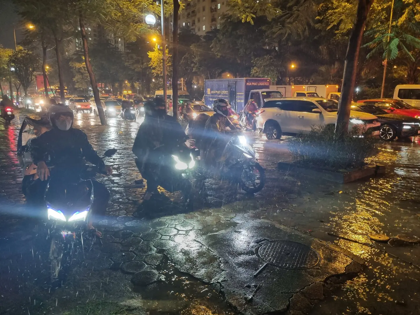 Nhiều xe máy đi tràn lên vỉa hè do ngập và tắc đường